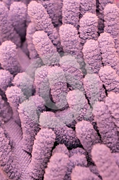 Macro close up of pink chenille microfiber texture for cleaning, trapping dust