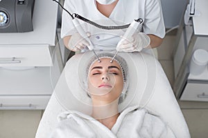 Macro close up portrait of woman having cosmetic galvanic beauty treatment in spa.Therapist applying low frequency