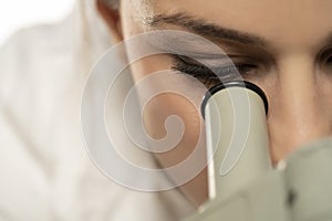 Macro Close Up Shot of a Female Scientist Looking into the Microscope