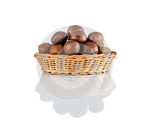 macro or close-up side view of chestnut in a wicker basket and reflection isolated on white background, Suitable for creative