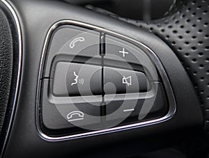 A macro close up view of command buttons on the steering wheel