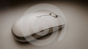 macro close-up of white wireless computer mouse isolated on dramatic technology modern presentation