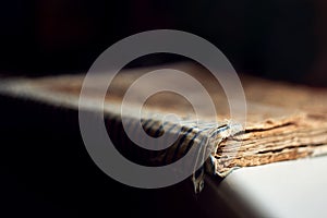 Macro closed old antique bible book with sticky cover on a dark background close-up