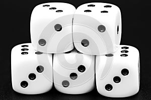 Macro closeup of arranged white dice in front of dark background