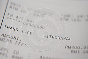 Macro closeup of a auto teller machine bank slip. selective focus on WITHDRAWAL word