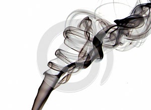 Macro closeup of black transparent silky smoke floating with elegant soft swirls into the air isolated on white background