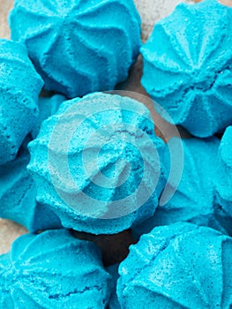 Macro closeup of dish with blue sweet meringues