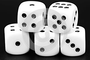 Macro closeup of five dice in front of dark background