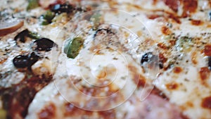 Macro closeup of freshly baked super supreme pizza in restaurant