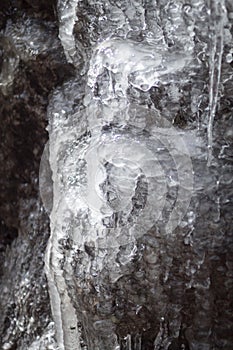 Macro closeup of icicles formed on side of mountain