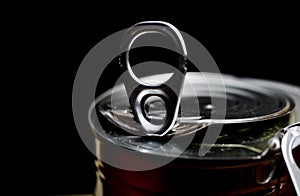 Macro closeup of isolated shiny metal food can with black background