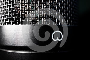 Macro Closeup of Large Diaphragm Condenser Microphone Cardioid Polarity Symbol and Grill