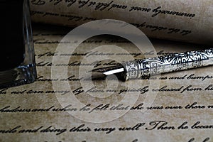 Macro closeup of retro ink pen, old vintage paper with handwritten text