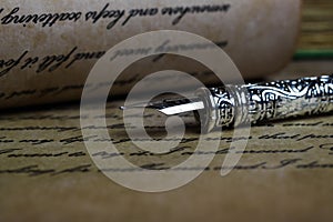 Macro closeup of retro ink pen, old vintage paper with handwritten text