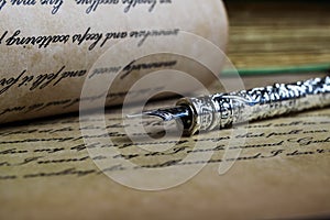 Macro closeup of retro ink pen, old vintage paper with handwritten text