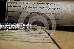 Macro closeup of retro ink pen, old vintage paper with handwritten text