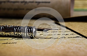 Macro closeup of retro ink pen, old vintage paper with handwritten text