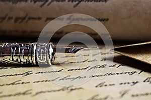 Macro closeup of retro ink pen, old vintage paper with handwritten text