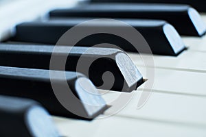 Macro closeup shot of a pianos white and black keys in a shallow depth of field