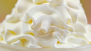 Macro closeup of swirls of whipped cream for cake decorating.