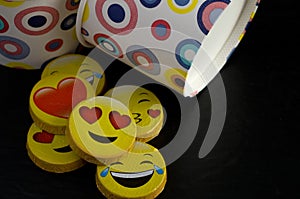 Macro of Colorful Bowls with Yellow candies Wrapped in Smiley Faces