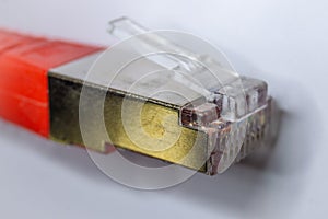 Macro cross section front angle view of red RJ45 CAT6 shielded network data internet cable clear connector