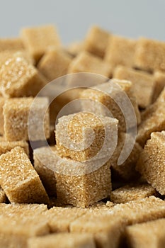 Macro cubes of brown cane unrefined demerara sugar.