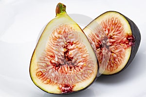 Macro of cut fig halves on white background