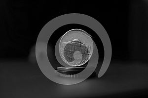 Macro detail in black and white of an American coin five cents of American dollar, USD on the top of column created of coins