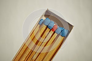 Macro detail of a box of matches matchbox full of matches with blue top and one different with a red top