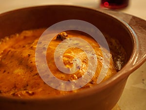 Macro detail of lasagna in clay pot