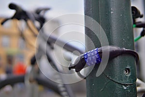 Macro detail of a metal four digits bike combination lock used for ensuring security and safety of a bike in a city