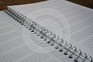 Macro detail of a notepad with paper lined as piano sheet with lines prepared for composing music