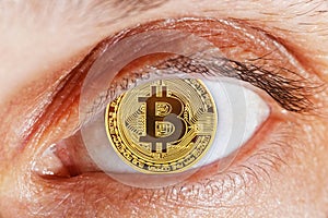 Human eye with coin bitcoin instead of pupil