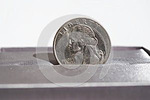 Macro detail of a silver coin of One American Dollar (USD, United States of America Dollar)