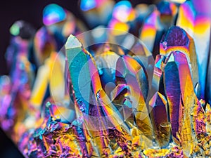 Macro detail of Titanium rainbow aura quartz crystal cluster stone with shallow depth of field