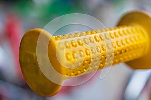 Macro detail of a yellow handle on an eighty's kid bike