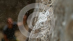 MACRO: Magnesium particles fly around a crimp hold after climber slips and falls