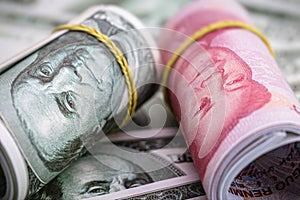 Macro of dollar bills and China yuan or Renminbi banknotes, Chinese and US economy finance commercial business, money closeup