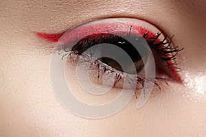 Macro eye with fashion bright red eyeliner make-up