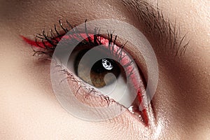 Macro eye with fashion bright red eyeliner make-up