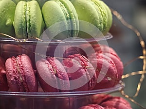 Macro f pink and green macarons on a cake stand