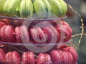 Macro f pink and green macarons on a cake stand
