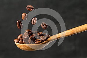 Macro falling coffee bean on gray background