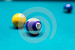 Macro focus on billiard ball, blue table background