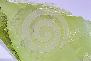 Macro focused raw shiny semi-transparent light lime green, pistachio calcite stone