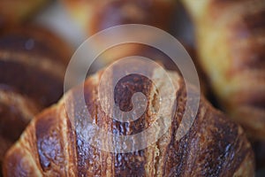 Macro food photography of home baked breakfast croissants made with flaky pastry and a stripe pattern finish and blur background