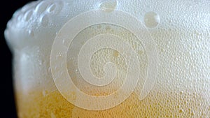 Macro footage shot,Pour the beer into the glass until the beer bubbles over the glass.