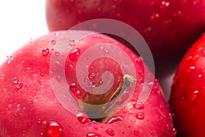 Macro of fresh red wet apples with drops.