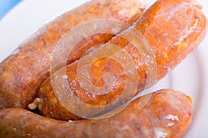 Macro of frozen pork sausage on a plate